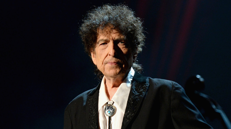 Bob Dylan wearing a white shirt and black jacket