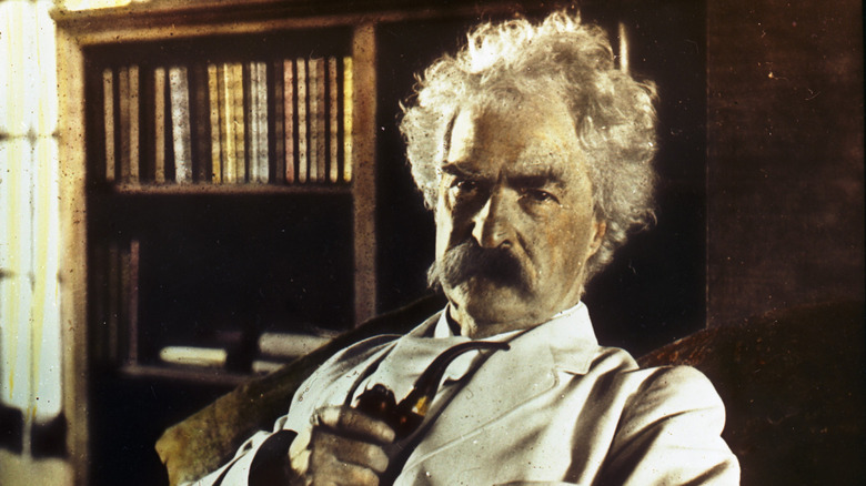 Mark Twain holding a pipe