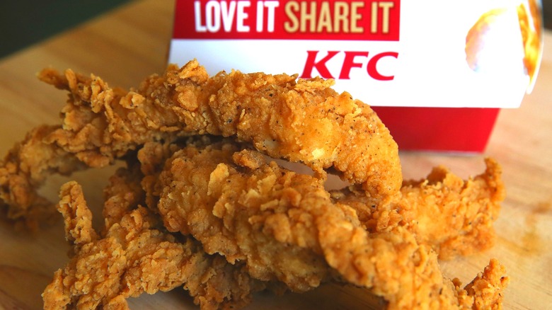 Close-up of chicken tenders in front of a KFC box