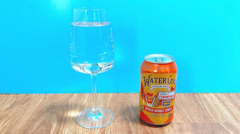 Glass and can of Waterloo Sparkling Water and Guy Fieri's Flavortown Spiced Mango Sorbet