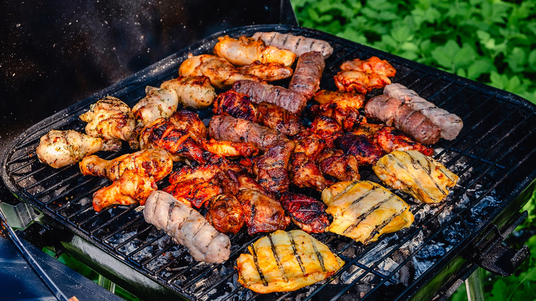 An assortment of meats on an outdoor grill