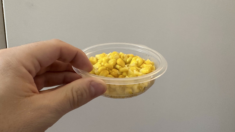 Hand holding side of KFC corn