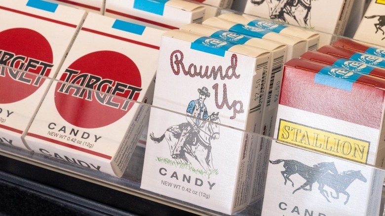 Candy cigarette boxes neatly arranged on a store shelf