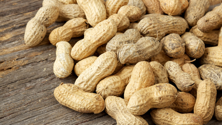 A pile of whole peanuts in their shells
