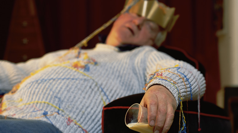 A man wearing a festive hat, passed out drunk