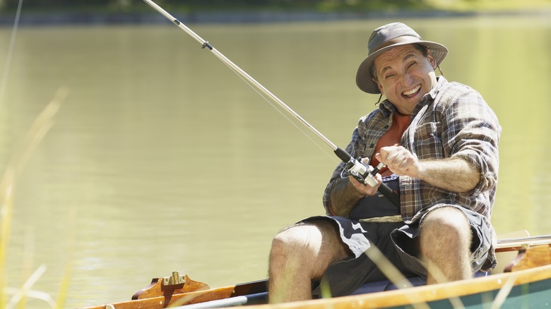 Person happily fishing on a boat